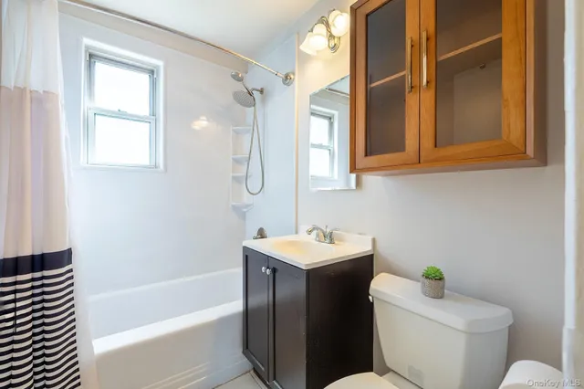 a bathroom with a sink a toilet and bathtub
