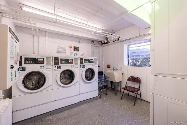 a utility room with dryer washer and a window