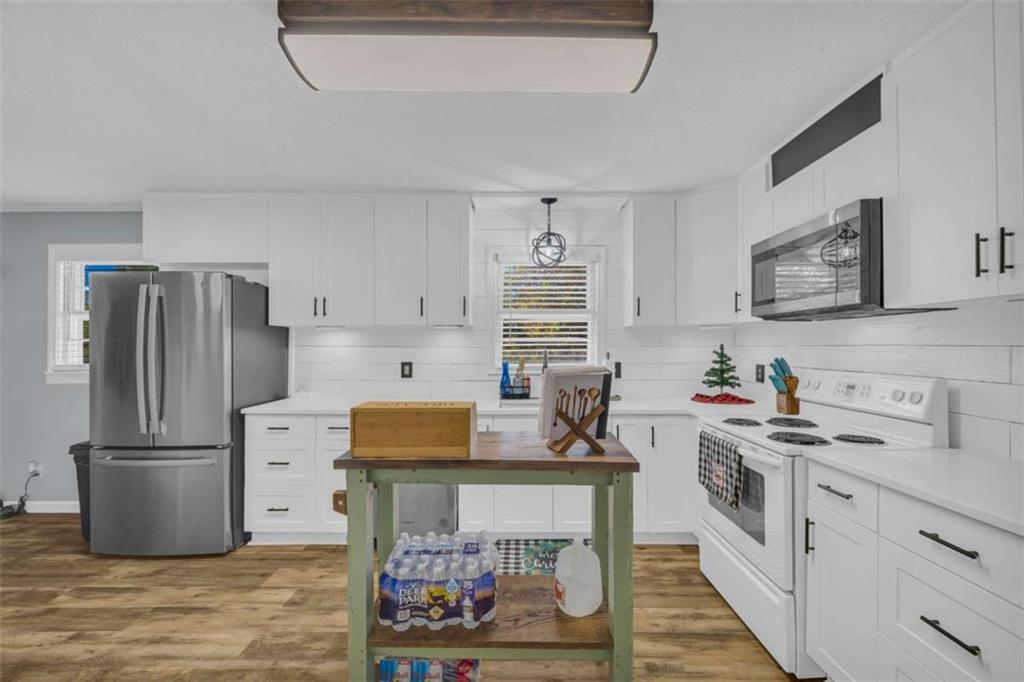 97 Williams Street Toccoa, GA 30577 - Photo 12 of 55 a kitchen with stainless steel appliances a stove a refrigerator and a sink