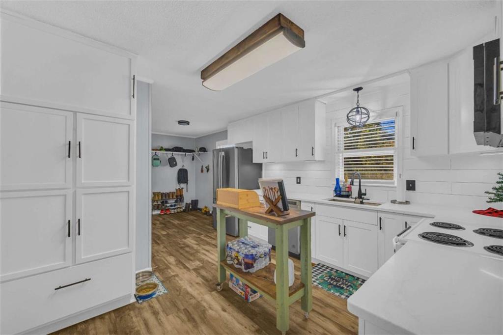 97 Williams Street Toccoa, GA 30577 - Photo 14 of 55 a kitchen that has a sink a stove and a table in it