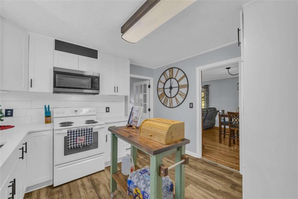 97 Williams Street Toccoa, GA 30577 - Photo 15 of 55 a view of a kitchen with fridge and wooden floor