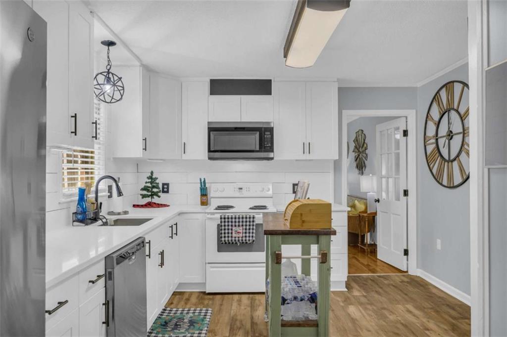 97 Williams Street Toccoa, GA 30577 - Photo 18 of 55 a kitchen with a sink cabinets and wooden floor