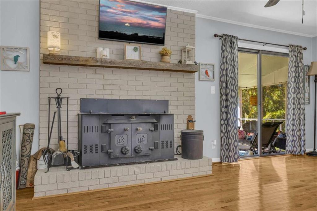 97 Williams Street Toccoa, GA 30577 - Photo 22 of 55 a living room with a fireplace and a flat screen tv