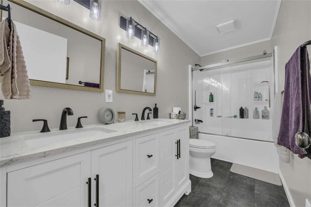 97 Williams Street Toccoa, GA 30577 - Photo 27 of 55 a bathroom with a sink a toilet and a mirror