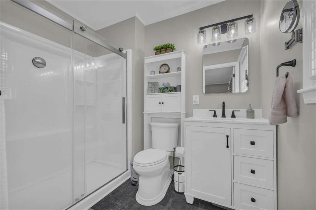 97 Williams Street Toccoa, GA 30577 - Photo 30 of 55 a bathroom with a sink a toilet and shower