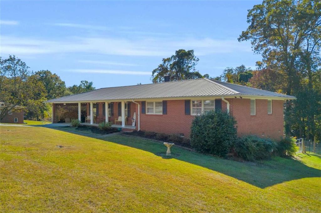 97 Williams Street Toccoa, GA 30577 - Photo 3 of 55 a front view of a house with yard and green space