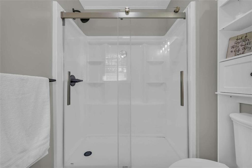 97 Williams Street Toccoa, GA 30577 - Photo 31 of 55 a bathroom with a shower and toilet