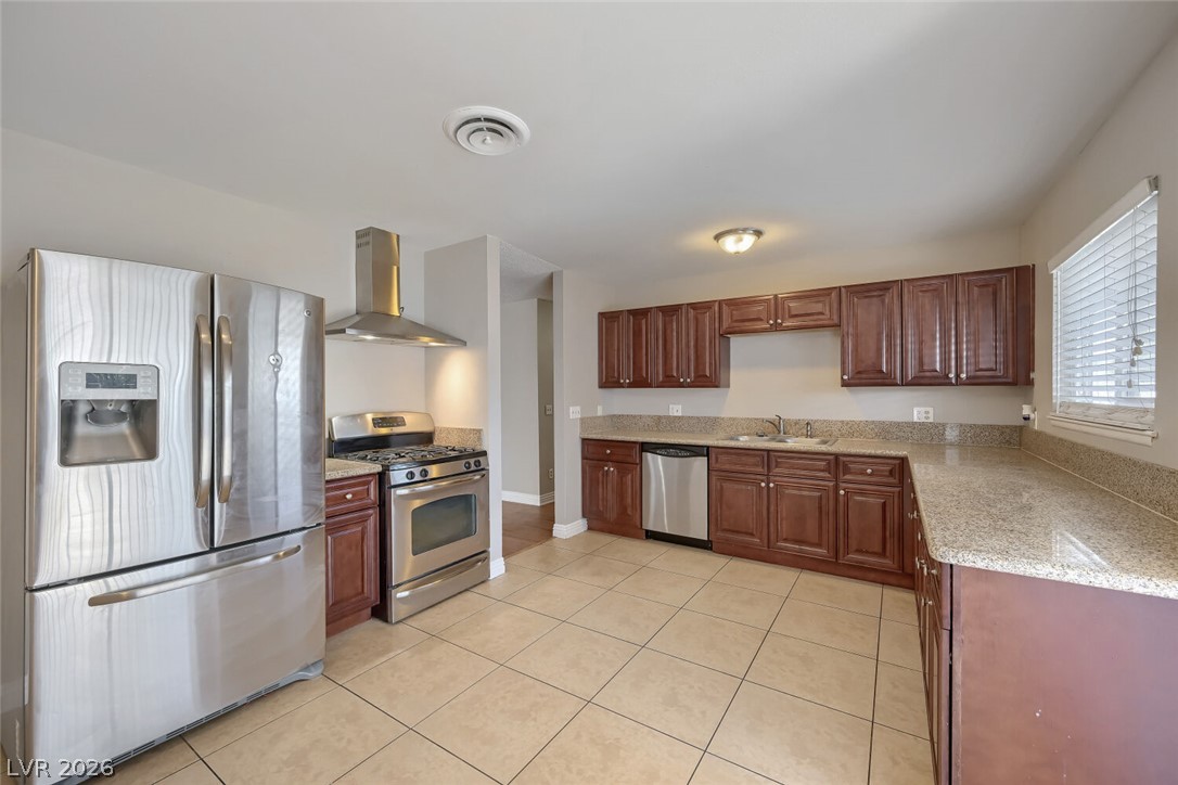 6321 Portola Road Las Vegas, NV 89108 - Photo 20 of 29 Well-equipped kitchen with tile flooring and ample counter space, perfect for culinary endeavors.