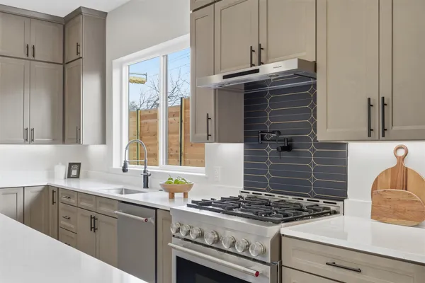 a kitchen with granite countertop a stove and a sink
