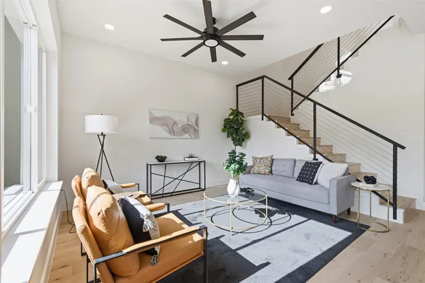 a living room with furniture and a wooden floor