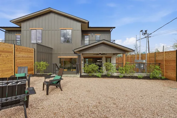 a view of a house with a yard and sitting area