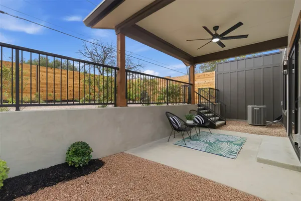 a building outdoor space with patio furniture and a potted plant