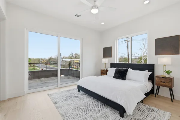 a bedroom with a large bed and a tv