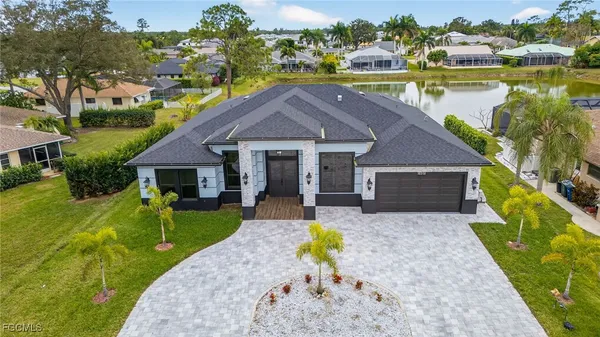 a front view of house with yard and lake view
