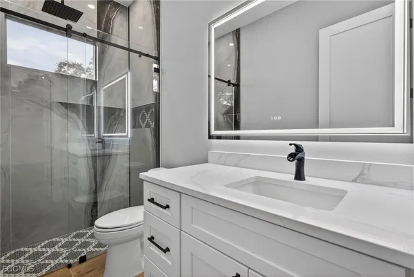 a bathroom with a sink toilet and shower