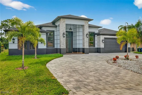 a front view of a house with garden