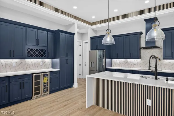 a kitchen with stainless steel appliances kitchen island a wooden floor