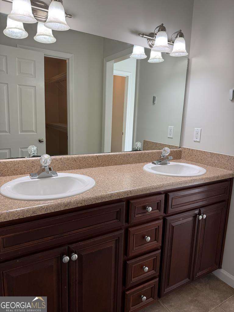4125 Springruff Drive Valdosta, GA 31602 - Photo 15 of 22 a bathroom with a granite countertop sink a light fixture and a mirror