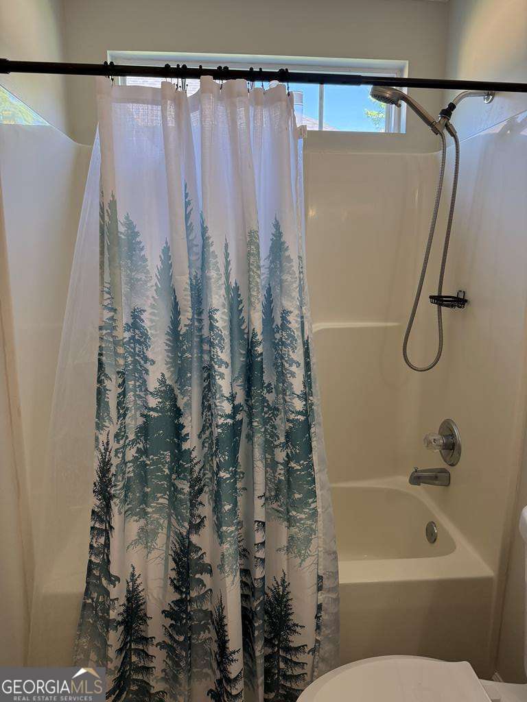 4125 Springruff Drive Valdosta, GA 31602 - Photo 17 of 22 a bathroom with a shower curtain and a toilet