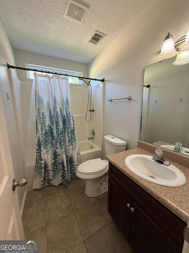 4125 Springruff Drive Valdosta, GA 31602 - Photo 18 of 22 a bathroom with a granite countertop sink toilet a mirror and shower