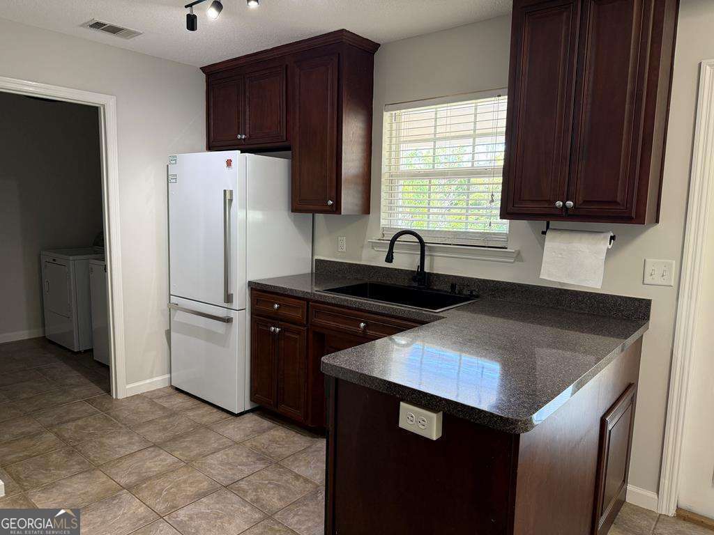4125 Springruff Drive Valdosta, GA 31602 - Photo 8 of 22 a kitchen with a sink cabinets and refrigerator