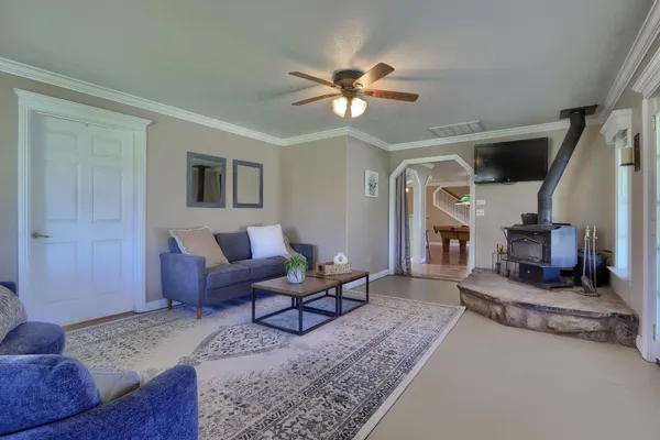 a living room with furniture windows and a chandelier