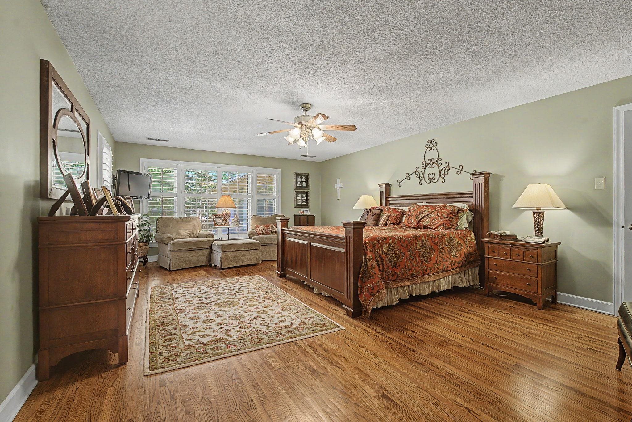 1929 Miller Farms Road Germantown, TN 38138 - Photo 19 of 40 Hardwood flooring extends throughout this room, featuring light green walls and a textured white ceiling