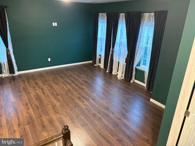 a view of a room with wooden floor