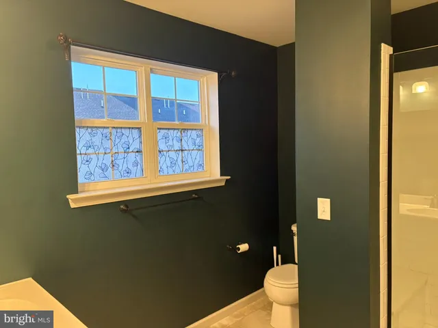 a bathroom with a glass shower door