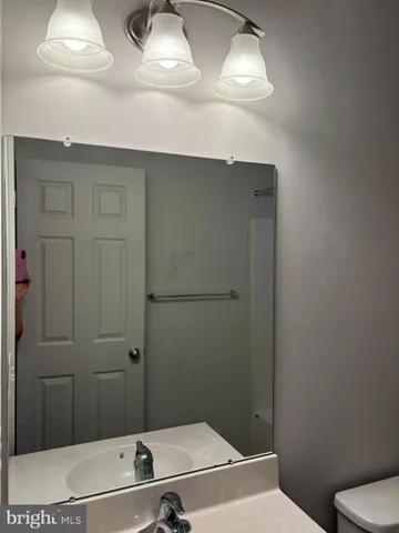 a view of a livingroom with wooden floor and windows