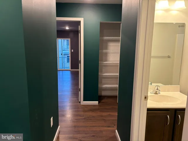 a view of empty room with wooden floor and window