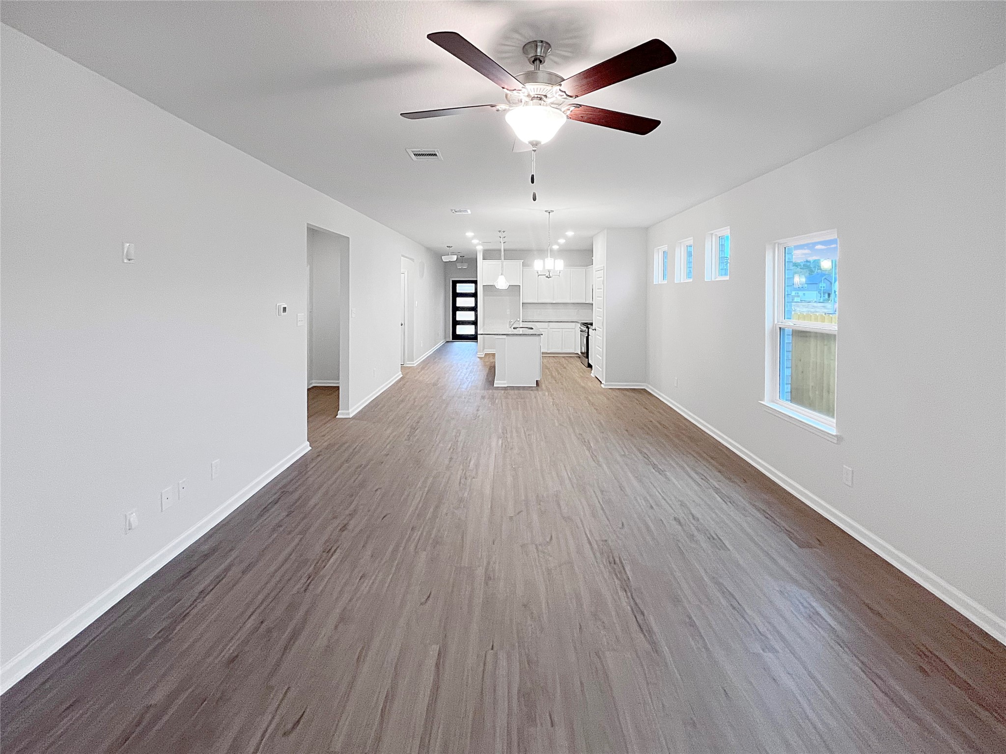 9706 Enclave Ridge Road Willis, TX 77318 - Photo 9 of 19 a view of a livingroom with a hardwood floor and a ceiling fan