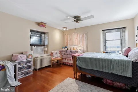 a bedroom with two beds and a window