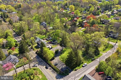 an aerial view of a house with a yard and garden