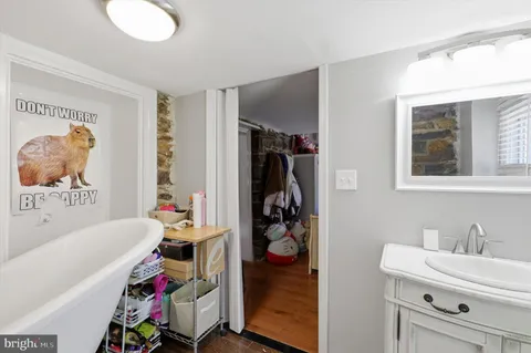 a bathroom with a tub sink and a window