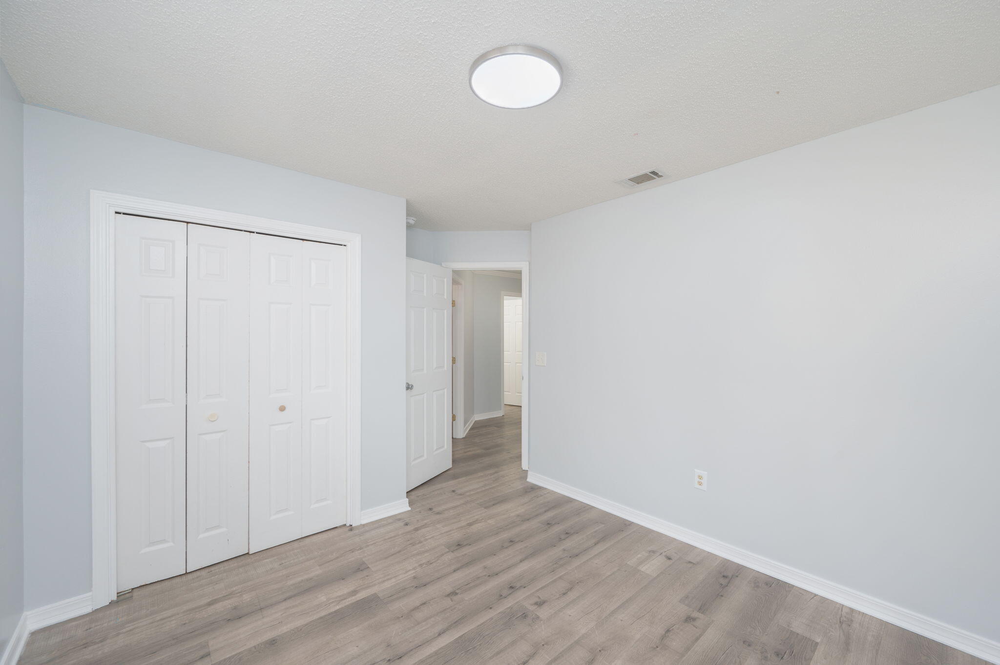 5249 Kervin Road Crestview, FL 32539 - Photo 17 of 27 a view of an empty room with wooden floor