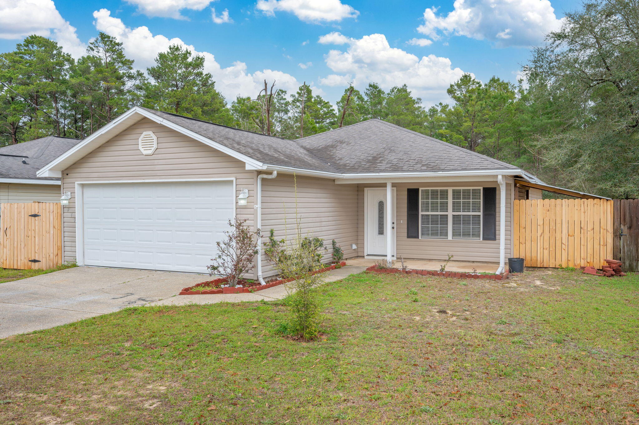 5249 Kervin Road Crestview, FL 32539 - Photo 2 of 27 a front view of a house with a yard and garage