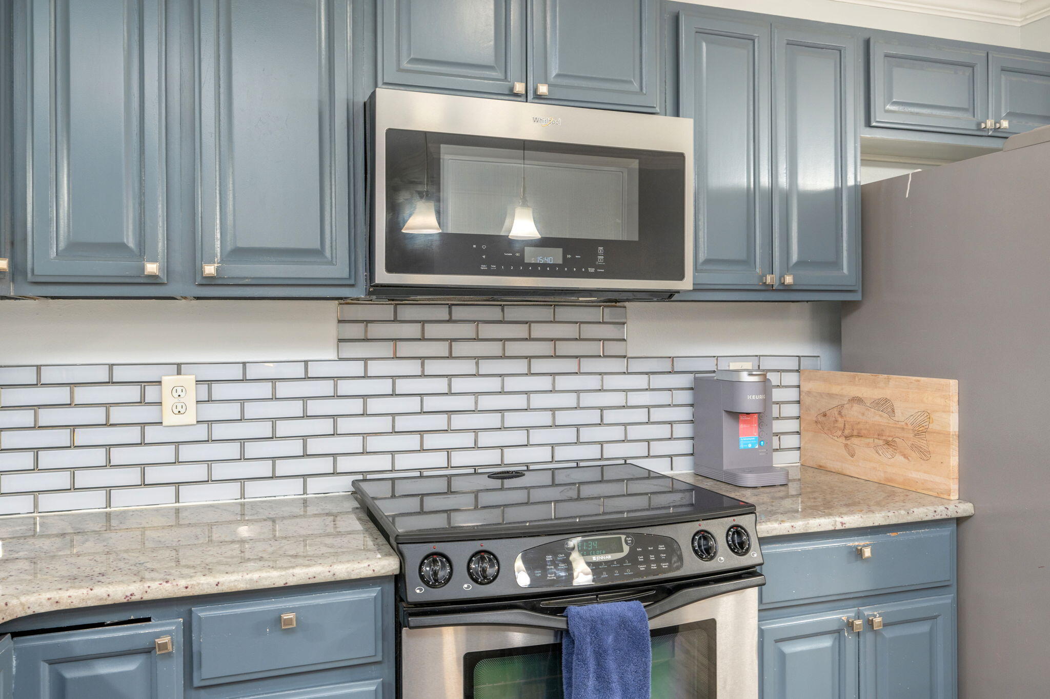 5249 Kervin Road Crestview, FL 32539 - Photo 8 of 27 a kitchen with granite countertop a stove top oven microwave and cabinets