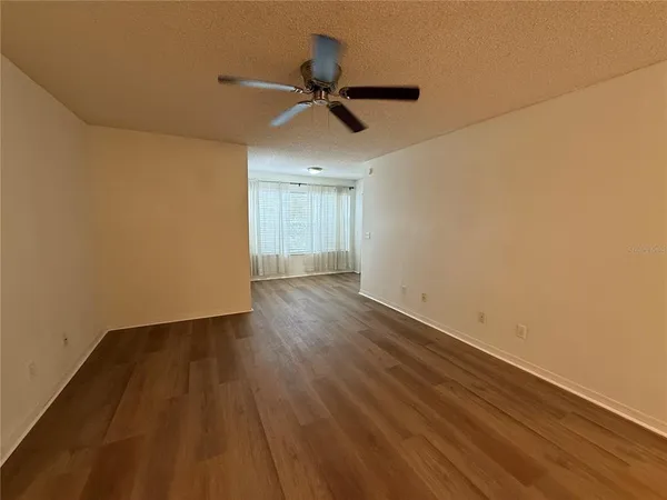 a view of an empty room and wooden floor