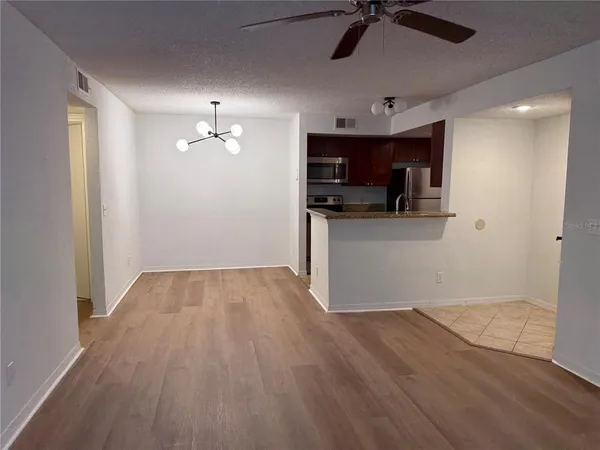 a kitchen with stainless steel appliances granite countertop a refrigerator and a stove top oven