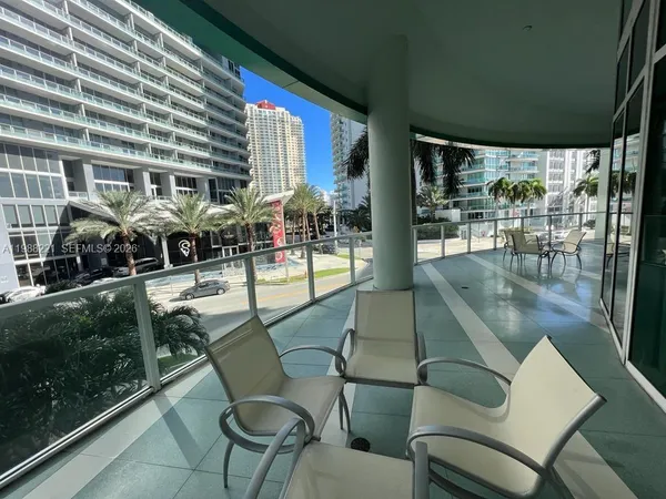 a view of a porch with chairs and backyard