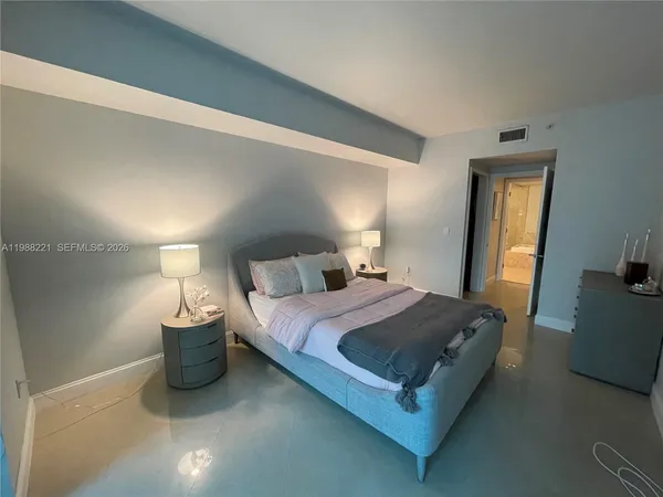 a bedroom with a bed and a mirror