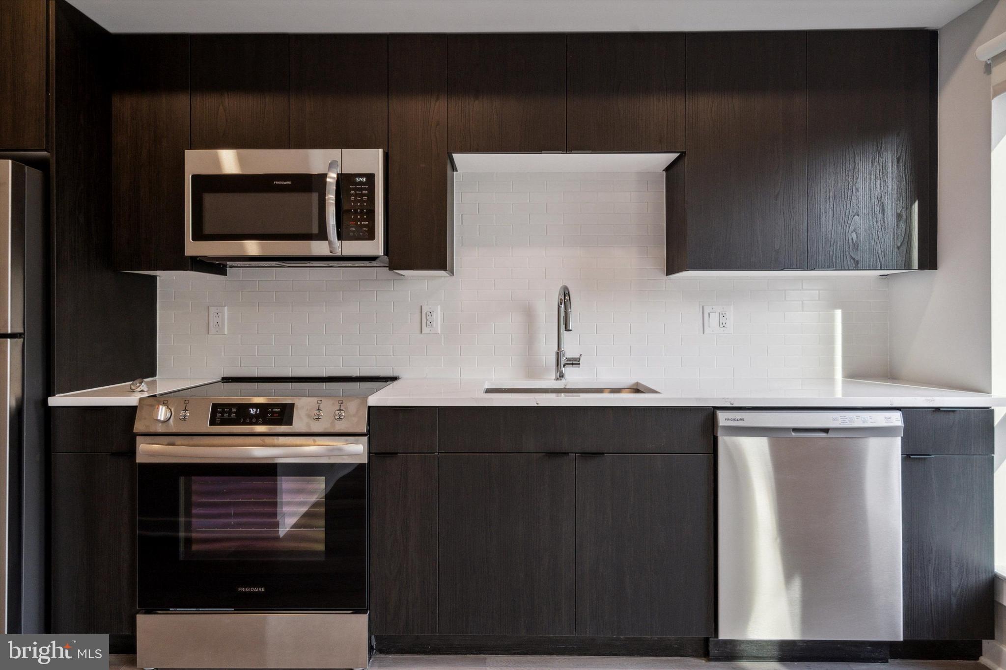 3449 Scotts Lane, Unit A306 Philadelphia, PA 19129 - Photo 2 of 9 a kitchen with a sink and a microwave