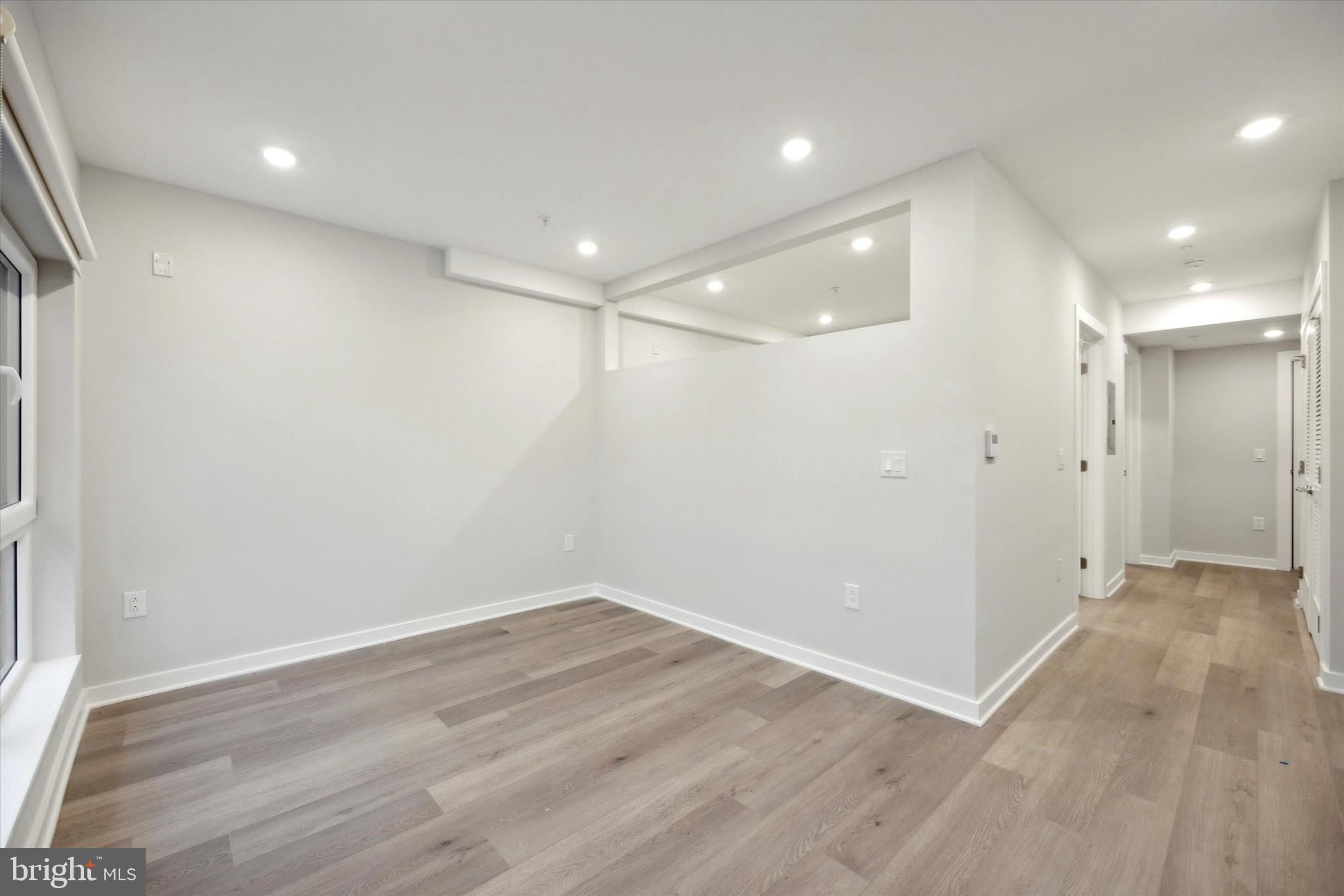 3449 Scotts Lane, Unit A306 Philadelphia, PA 19129 - Photo 6 of 9 a view of an empty room with wooden floor