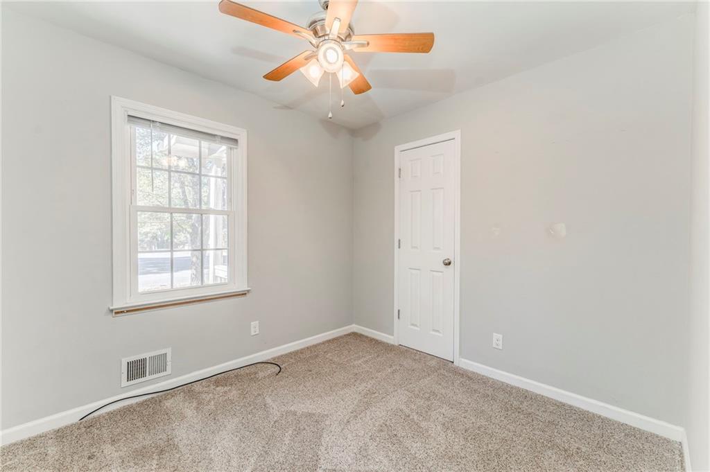 3016 Butler Creek Road Northwest Kennesaw, GA 30152 - Photo 11 of 43 an empty room with windows and fan