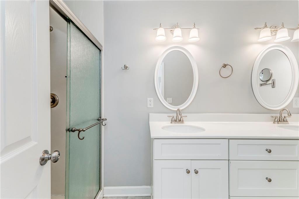 3016 Butler Creek Road Northwest Kennesaw, GA 30152 - Photo 23 of 43 a bathroom with a sink mirror and vanity