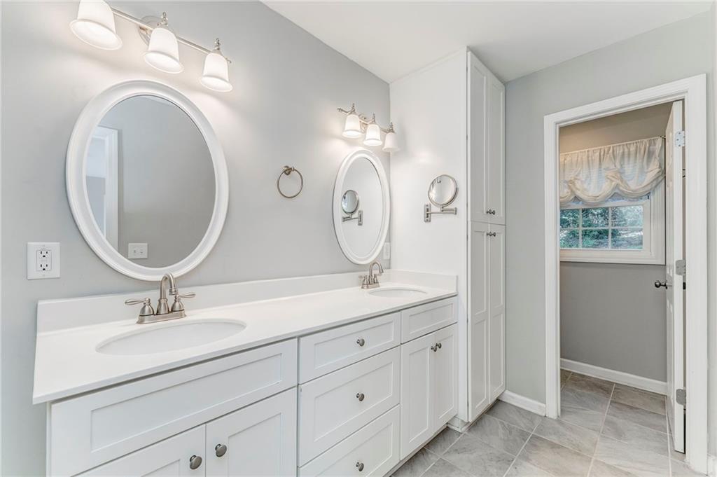 3016 Butler Creek Road Northwest Kennesaw, GA 30152 - Photo 24 of 43 a bathroom with a double vanity sink and a mirror