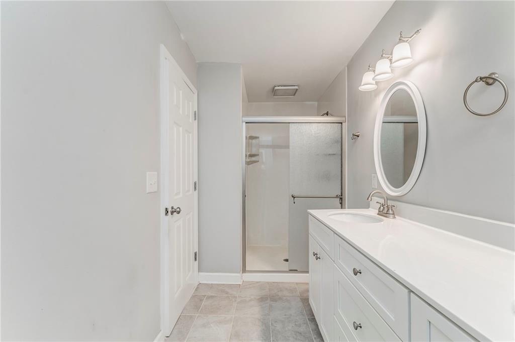 3016 Butler Creek Road Northwest Kennesaw, GA 30152 - Photo 25 of 43 a bathroom with a mirror and a sink