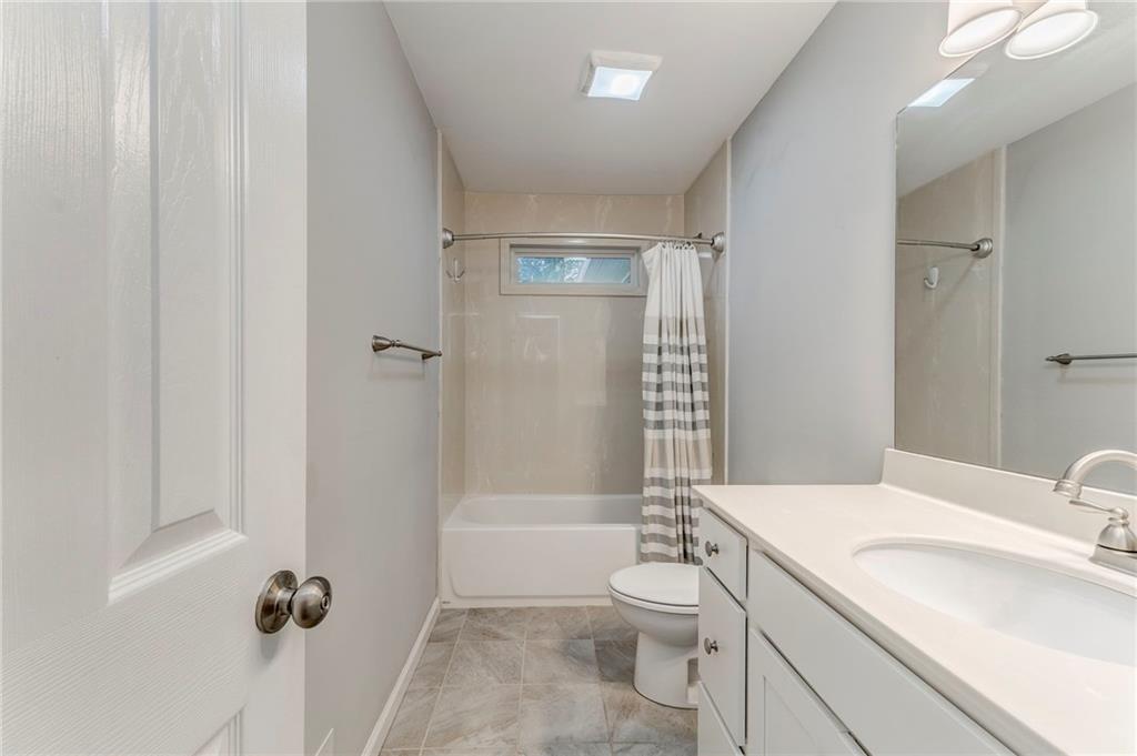 3016 Butler Creek Road Northwest Kennesaw, GA 30152 - Photo 26 of 43 a bathroom with a granite countertop sink toilet and shower