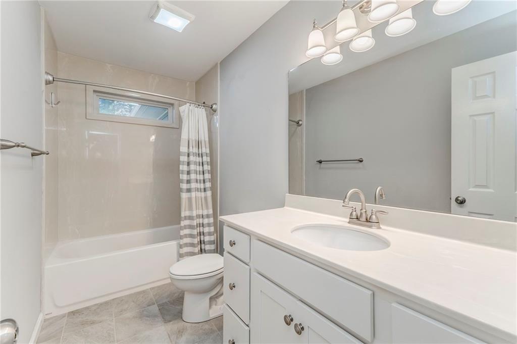 3016 Butler Creek Road Northwest Kennesaw, GA 30152 - Photo 27 of 43 a bathroom with a sink a toilet a mirror and shower